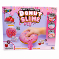A toy kit box for 'Make Your Own Donut Slime' featuring a pink box with illustrations of a strawberry-scented slime jar, a hand squeezing a pink donut-shaped slime toy, and instructions on the right side.