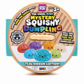 RMS Crazy Fun The Viral Mini Mystery Squishy Dumpling in the Teal Ribbon Edition, shown in its circular cardboard packaging with a clear window revealing a small beige squishy dumpling inside.
